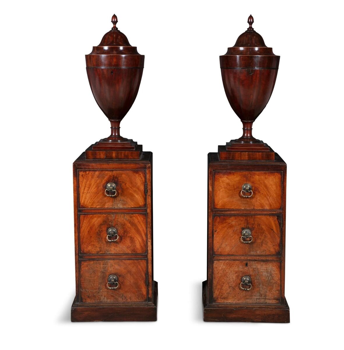 A pair of George III mahogany dining room urns on pedestals at Adam's.