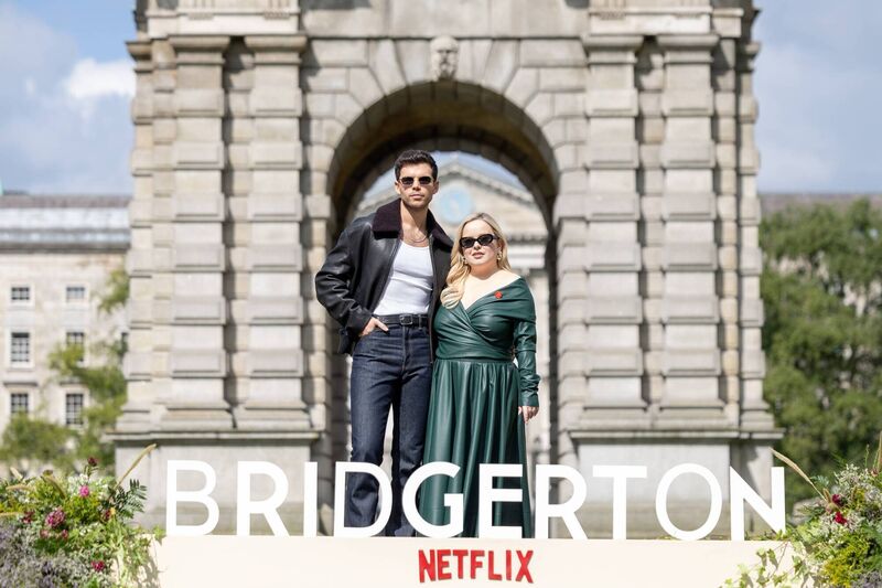 Luke Newton and Nicola Coughlan outside the Trinity College Dublin Campanile this morning at the launch of Bridgerton Season 3. Picture: Andres Poveda/Netflix