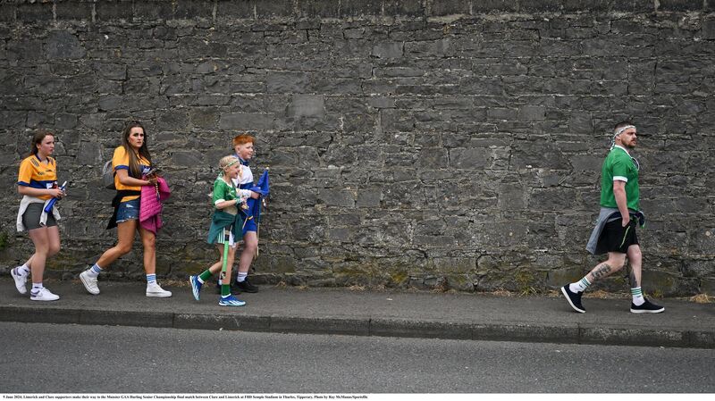 Limerick and Clare supporters make their way to the Munster final in Thurles. Pic: Ray McManus/Sportsfile