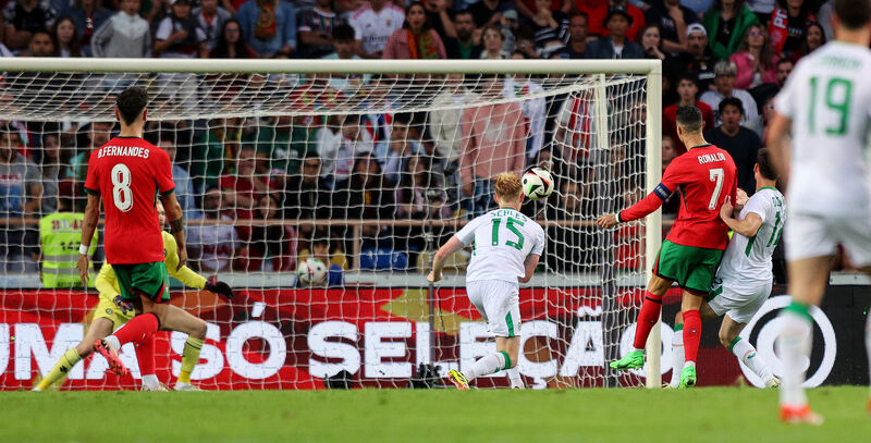 Portugal’s Cristiano Ronaldo scores his sides third goal. Pic Credit ©INPHO/Ryan Byrne