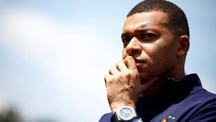 <p>French soccer player Kylian Mbappe listens to French President as he arrives for a lunch at the team's training camp. Pic: Sarah Meyssonnier / POOL / AFP) </p>
