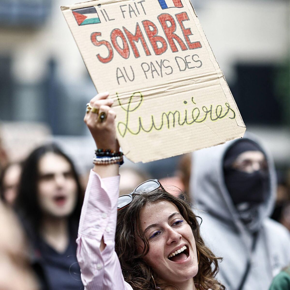 A protester holds a placard reading 'It is dark in the land of lights' as she demonstrates against the far right after their success in the European elections in France. Picture: Sameer Al-Doumy/AFP via Getty Images