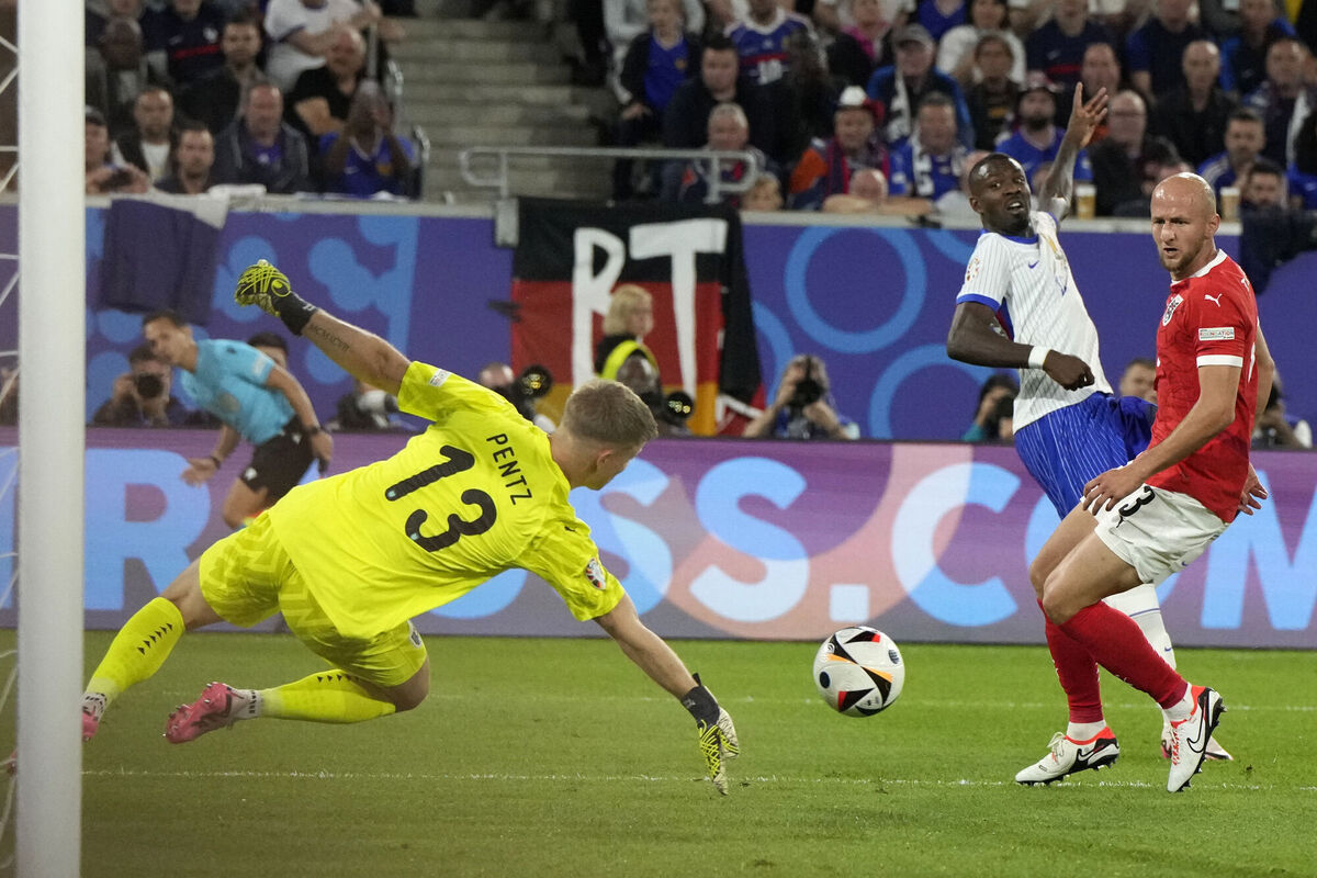 Austria's goalkeeper Patrick Pentz, left, makes a save from a shot by Marcus Thuram of France. (AP Photo/Martin Meissner)