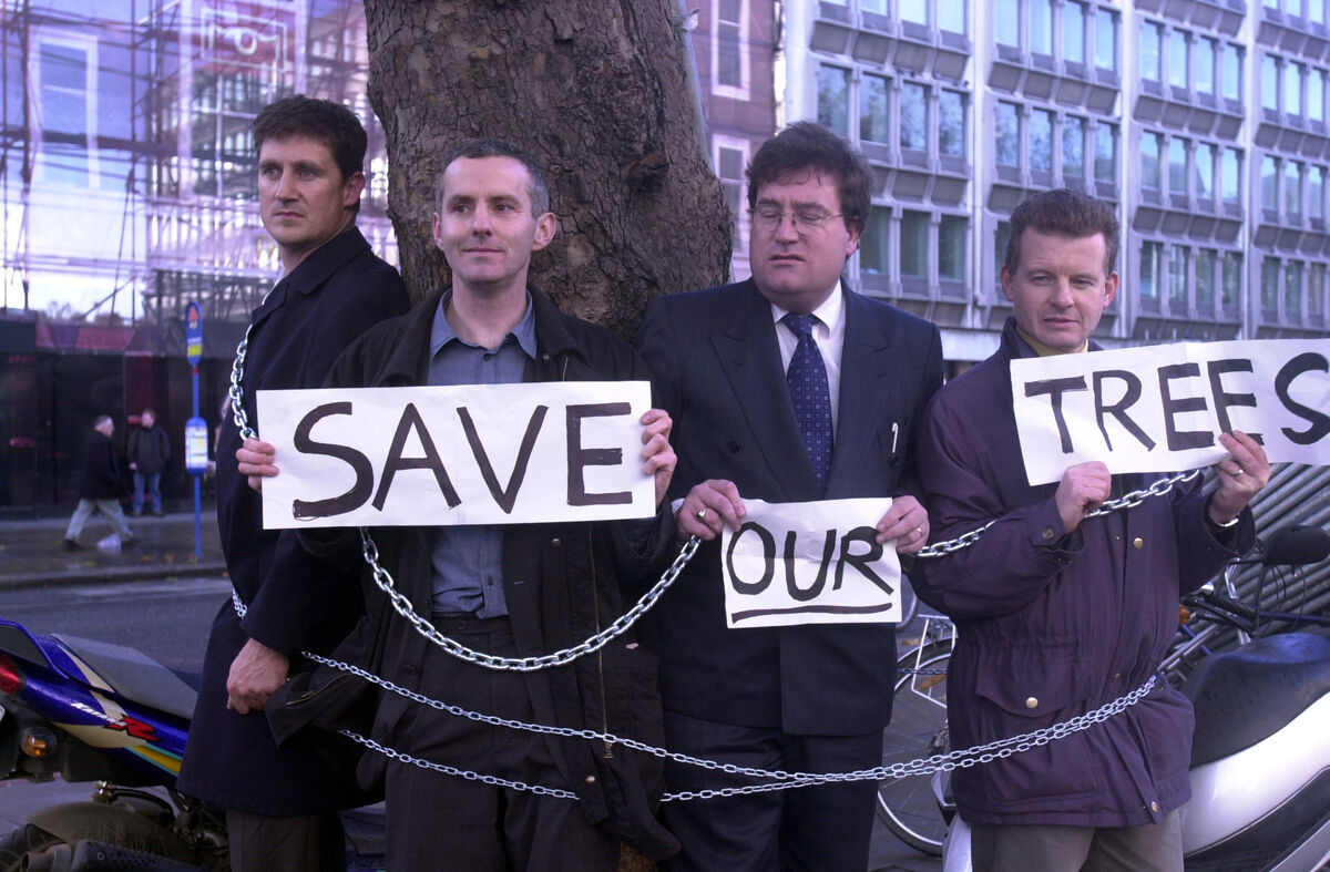 (Left to right) Green Party TDs Eamon Ryan, Ciaran Cuffs, Dan Boyle and Trevor Sargent chain themselves to trees in O'Connell Street, Dublin, in 2002 in protest over them being cut down. A blinkered commitment to save the planet has seen Ryan typecast as the bogeyman of farmers, the enemy of motorists, a curse for frequent flyers, and the butt of many jokes. File photo: RollingNews.ie