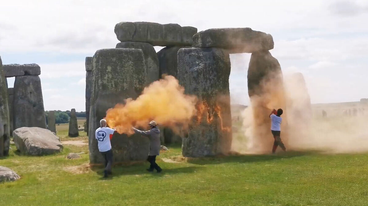 Screen grab taken from handout video of Just Stop Oil protesters spraying an orange substance on Stonehenge. Picture: Just Stop Oil/PA Wire
