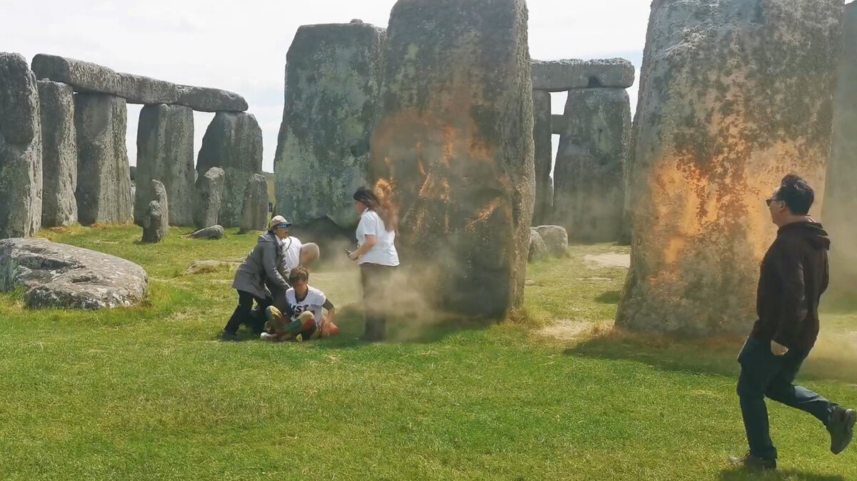 Screen grab taken from handout video of Just Stop Oil protesters spraying an orange substance on Stonehenge. Picture: Just Stop Oil/PA Wire