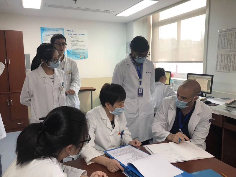 Dr Paul O'Brien leading a GI rotation case discussion with Chinese doctors during his internship in China. 