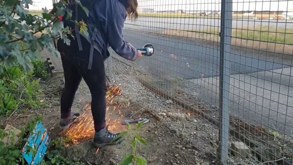 Screen grab taken from handout video of Just Stop Oil protesters cutting a hole in a fence at Stansted Picture: Just Stop Oil/PA Wire