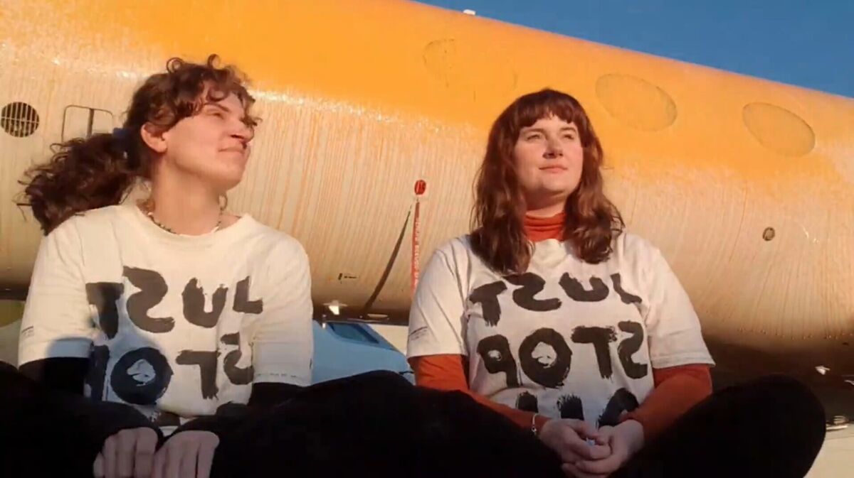 Screen grab taken from handout video of Just Stop Oil protesters Jennifer Kowalski (left), 28, a former sustainability manager from Dumbarton, and Cole Macdonald, 22, from Brighton, after they sprayed orange paint over parked private jets at London Stansted Airport
