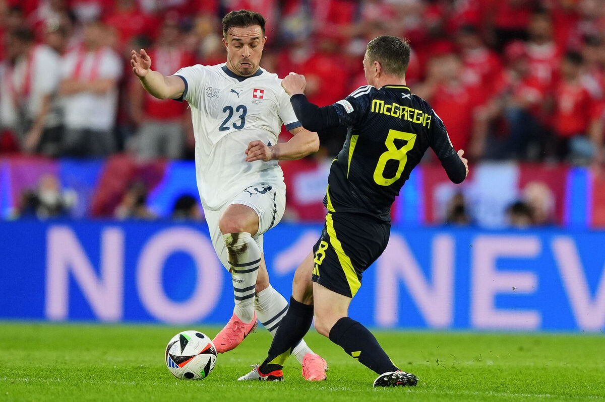 Switzerland's Xherdan Shaqiri and Scotland's Callum McGregor battle for the ball. Photo credit: Andrew Milligan/PA Wire.