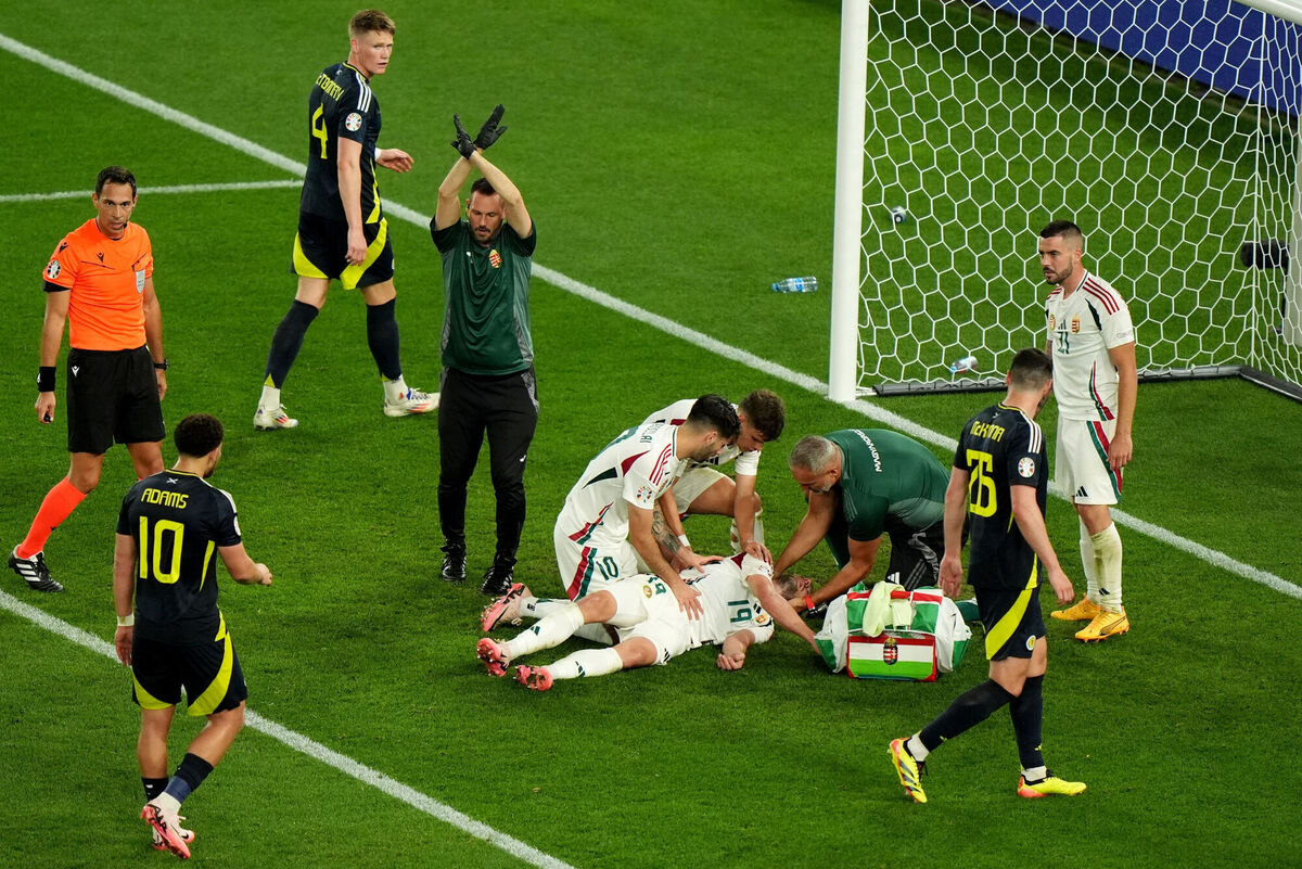 Hungary's Barnabas Varga (bottom) is assisted by his team mates and medical staff after colliding with Scotland goalkeeper Angus Gunn. Photo credit: Bradley Collyer/PA Wire.
