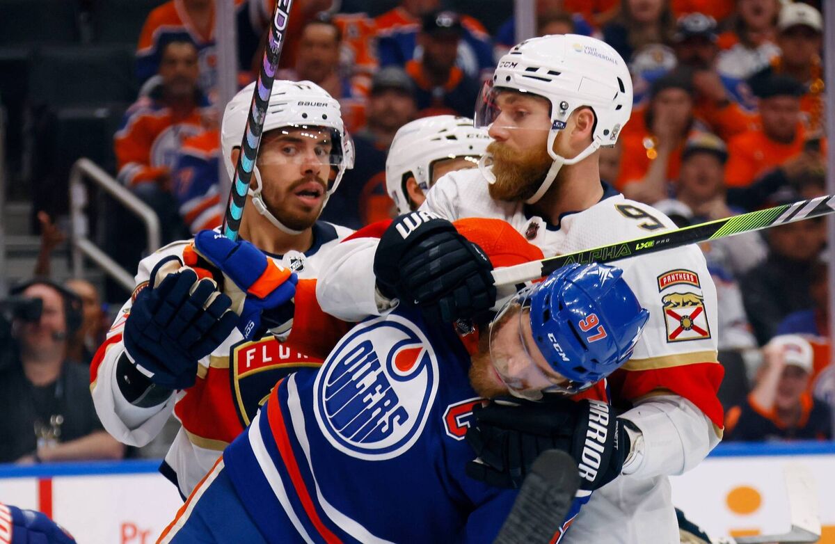 Sam Bennett #9 of the Florida Panthers grabs Connor McDavid #97 of the Edmonton Oilers in Game Six of the 2024 NHL Stanley Cup Final. Photo by Bruce Bennett/Getty Images.