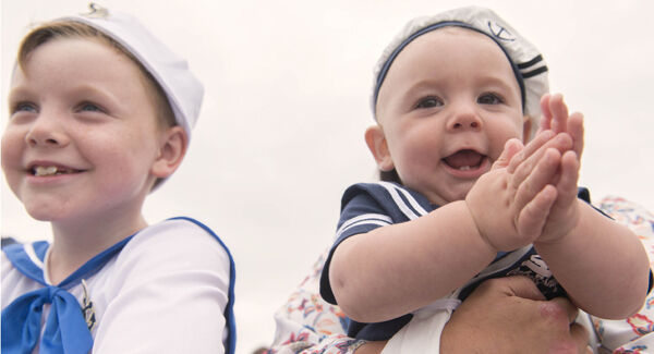 Nathan Henson, 7, and his brother Ethan, aged nine months, await the return of their father Colin aboard the LÉ Samuel Beckett.