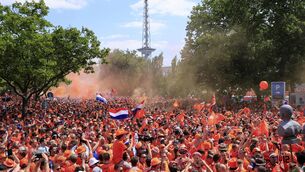 <p>LEFT RIGHT: Dutch fans gather ahead of the match against Austria. Pic credit: Carsten Koall/dpa via AP.</p>