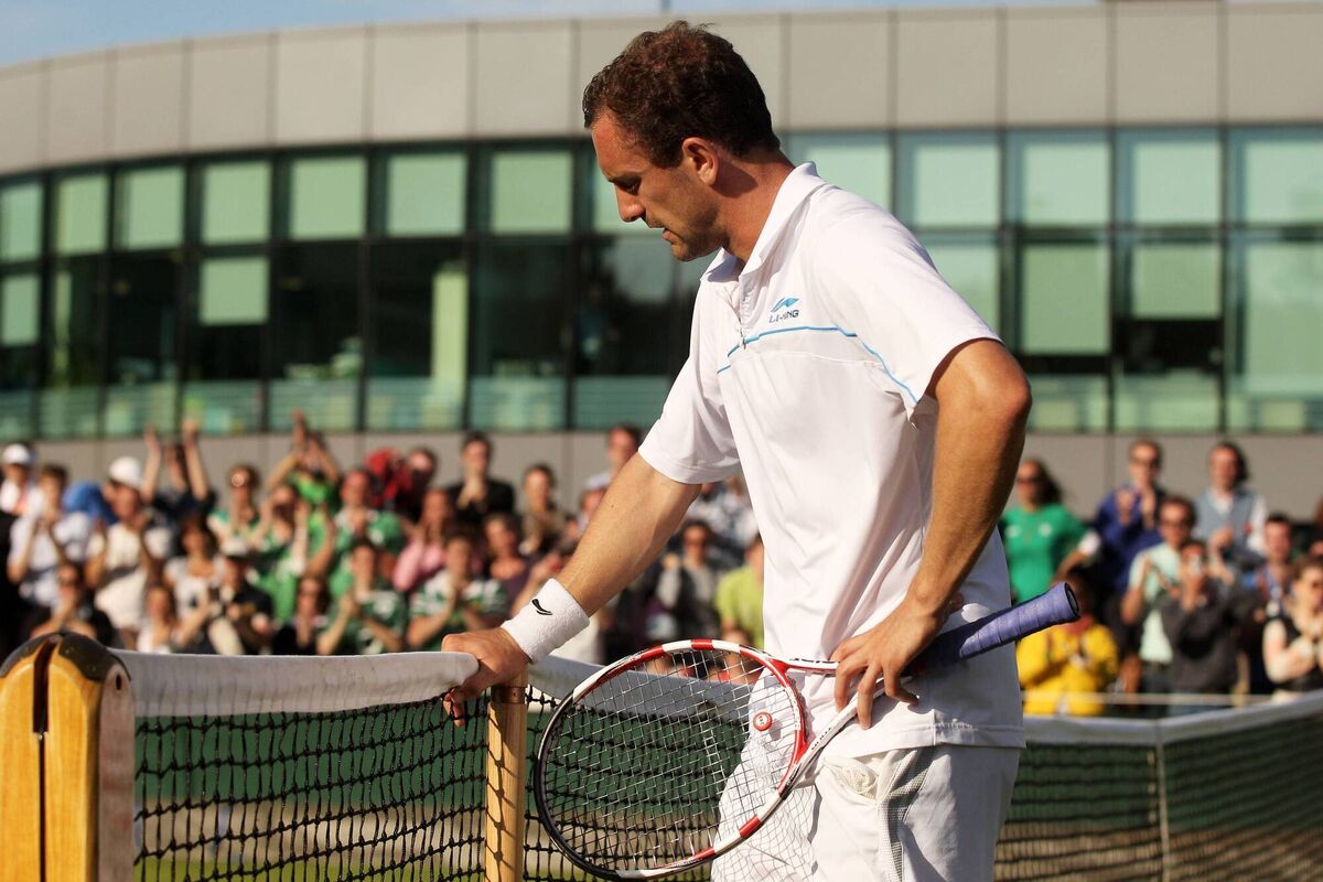 Niland reacts after losing his first round match against Adrian Mannarino at Wimbledon 2011