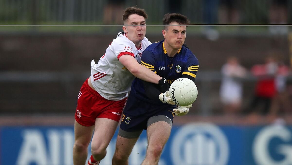 Tyrone's Eoin McElhone attempts to stop Conor Carroll in his tracks