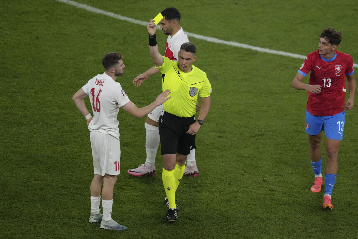 ANOTHER ONE: Referee Istvan Kovacs show the yellow card to Turkey's Ismail Yuksek during a Group F match between Czech Republic and Turkey. Pic: AP Photo/Sunday Alamba 