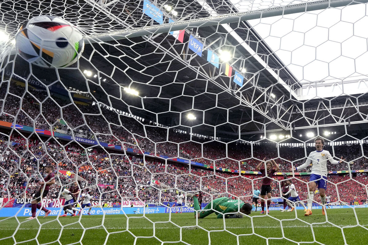 Antoine Griezmann celebrates after Belgium's Jan Vertonghen scored an own goal. AP Photo/Martin Meissner.