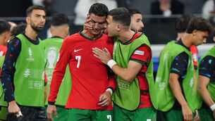 <p>CRYSTIANO: Portugal's Cristiano Ronaldo is consoled by Diogo Dalot at half-time of extra-time after missing a penalty. Photo credit: Bradley Collyer/PA Wire.</p>