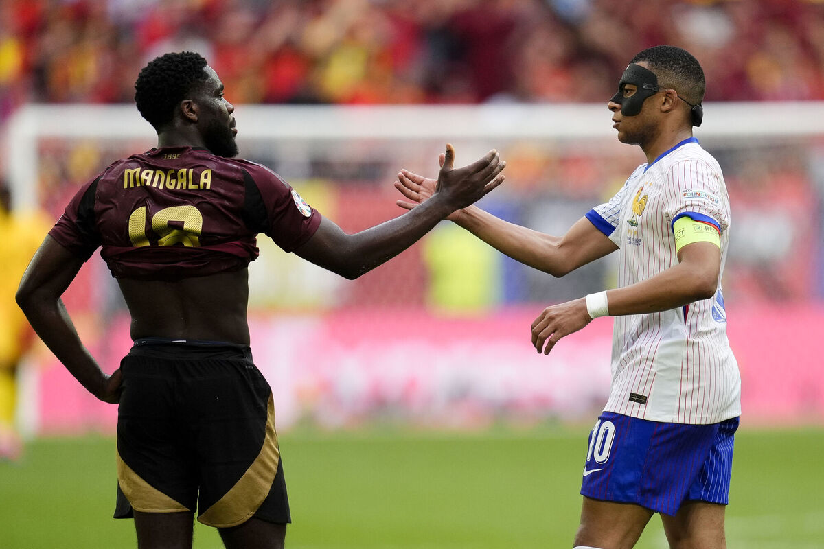 Orel Mangala shake hands with Kylian Mbappe after Belgium's loss to France in Euro 2024