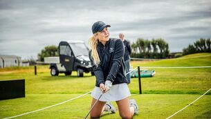 <p>Irish Girl Sara Byrne of Douglas anjd the International team has a go at driving from her knees pictured during the 1st days pracice ahead of this weekends Arnold Palmer Cup in Lahinch Golf Club, Clare. Pic: Brian Arthur</p>