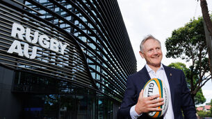 <p>Joe Schmidt poses for photographs outside the Rugby Australia headquarters. Pic: Max Mason-Hubers</p>