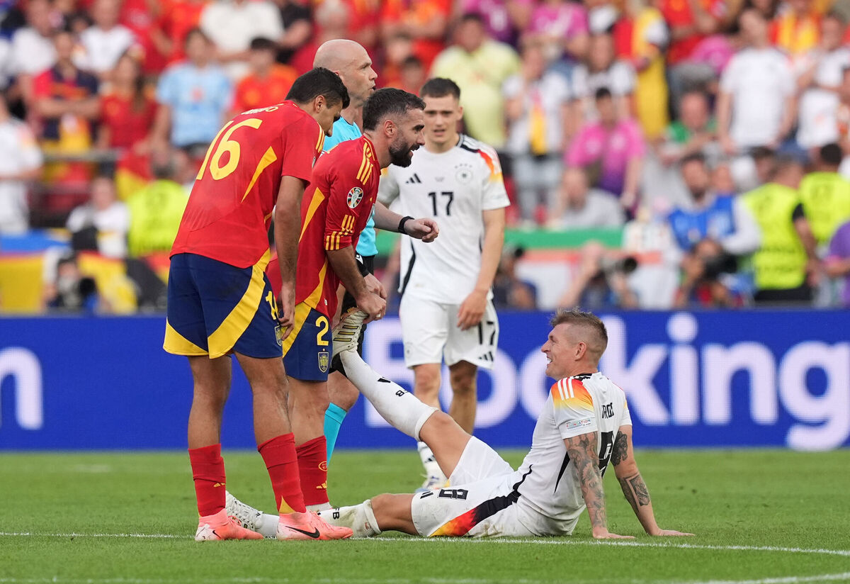 Kroos (right) receives help for cramp from former Real Madrid team mate Daniel Carvajal Kroos (right) receives help for cramp from former Real Madrid team mate Daniel Carvajal
