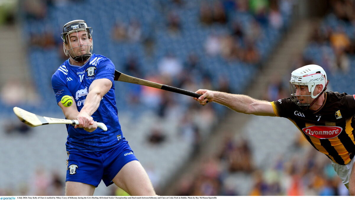 Clare's Tony Kelly, tackled here by Mikey Carey, hit some big frees down the stretch. Pic: Ray McManus/Sportsfile