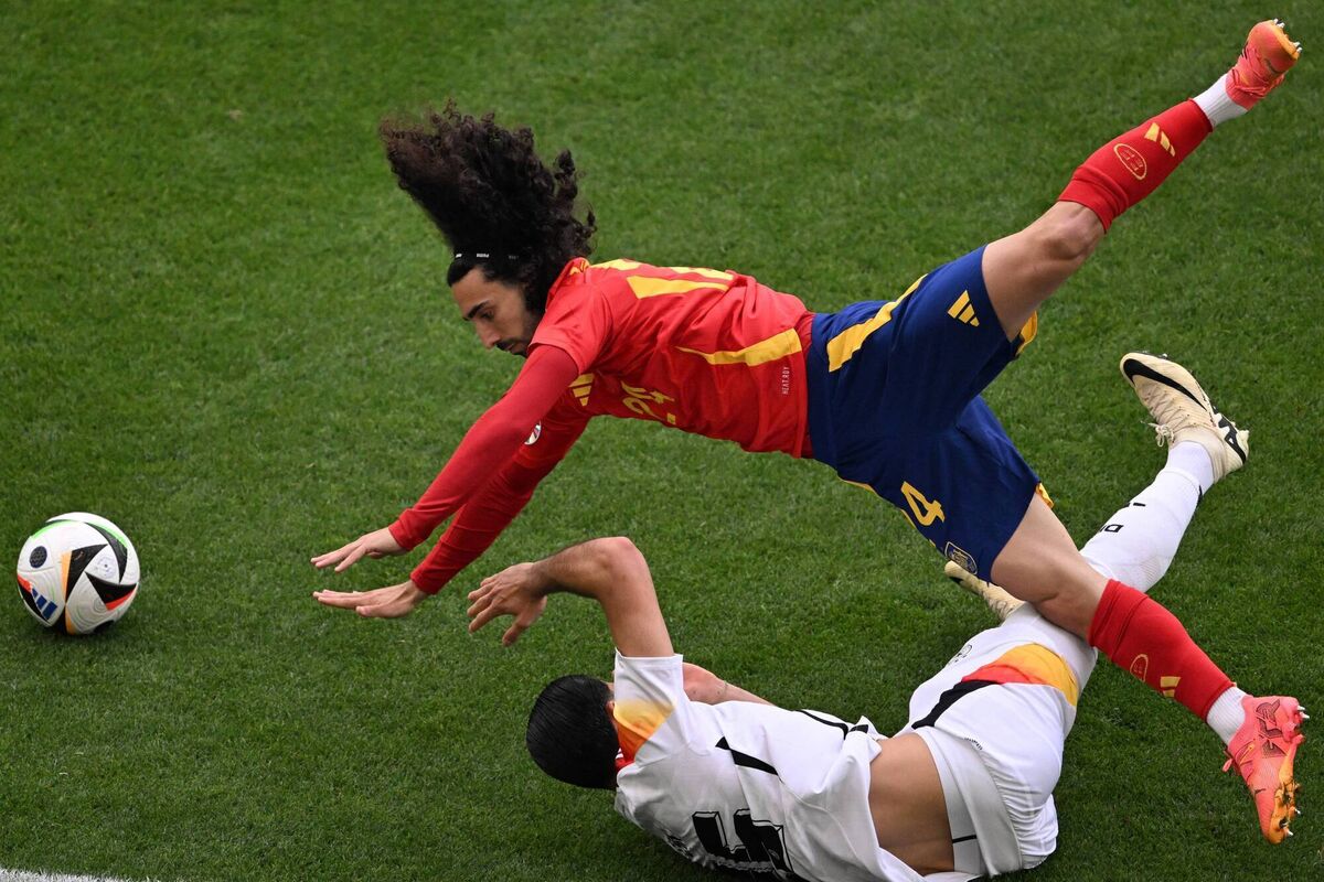 FLYING DEFENDER: Germany's midfielder Emre Can (bottom) and Spain's Marc Cucurella/ Photo by KIRILL KUDRYAVTSEV/AFP via Getty Images)