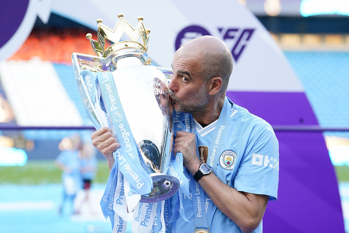 Manchester City manager Pep Guardiola kisses the Premier League title. Photo credit: Martin Rickett/PA Wire.