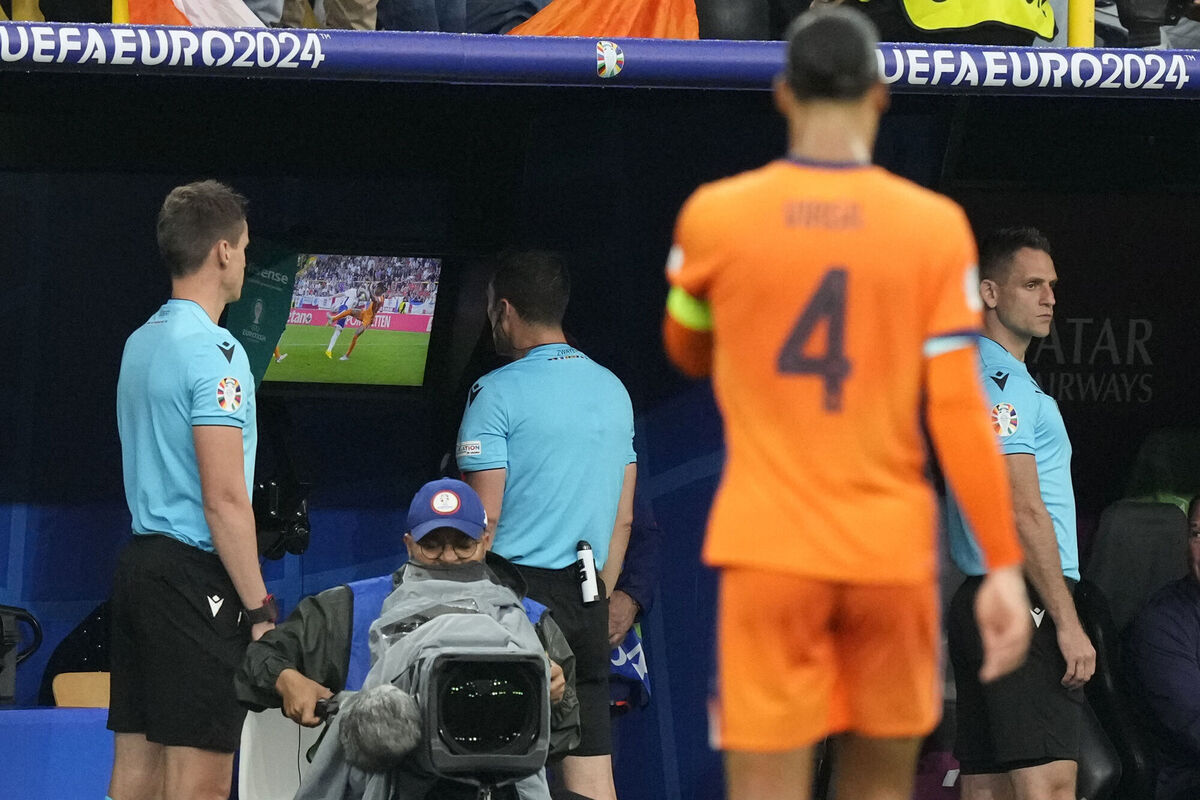 Referee Felix Zwayer checks the VAR. Pic: AP Photo/Frank Augstein