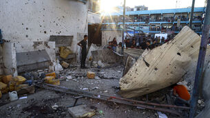 <p>Palestinians amid the wreckage after Israel's airstrike on a UN-run school that killed dozens of people in the Nusseirat refugee camp in Gaza  last Saturday. Picture: Saher Alghorra/AP</p>