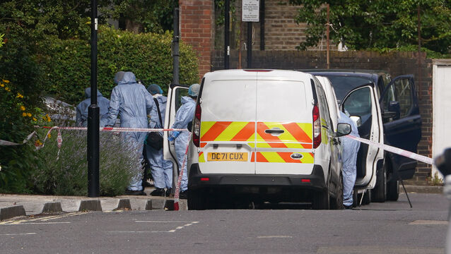 <p>Forensic officers at an address in Shepherd’s Bush, west London, after human remains were found in two suitcases near the Clifton Suspension Bridge in Bristol. Picture: Lucy North/PA</p>