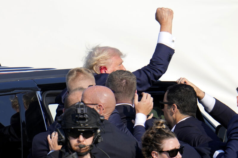 Republican presidential candidate former President Donald Trump pumps his fist as he is escorted into a vehicle at a campaign event in Butler, Pa., on Saturday, July 13, 2024. (AP Photo/Gene J. Puskar)