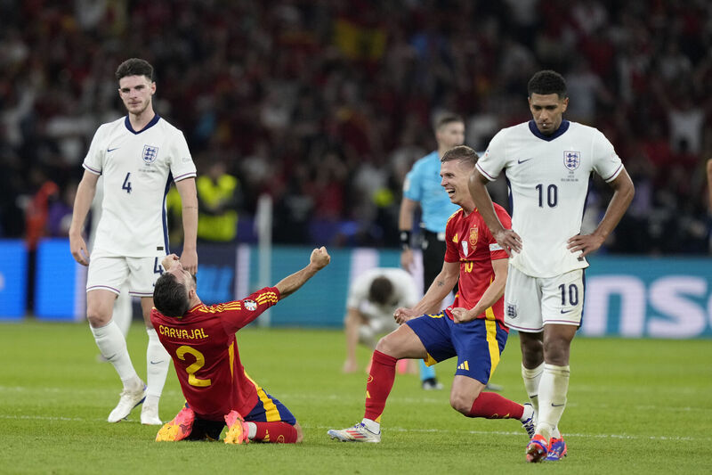 Spain's players celebrate after winning the final. Pic: Frank Augstein, AP