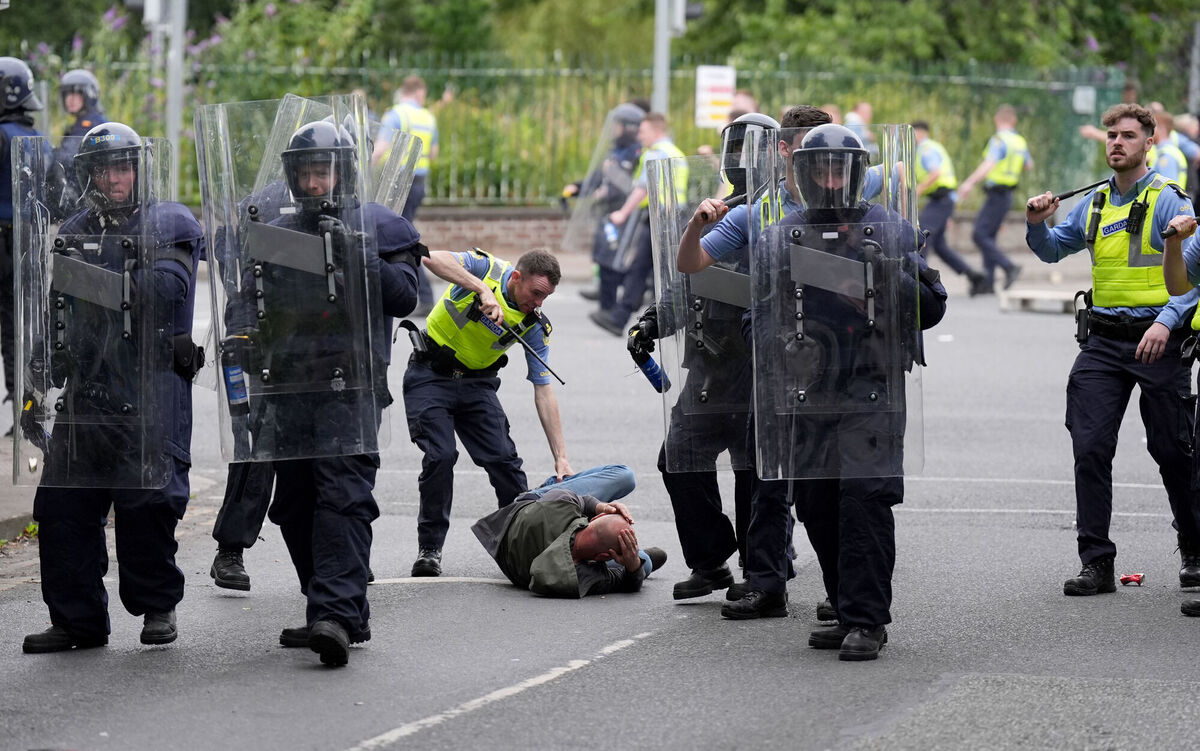 Gardaí detain a protesters after a number of fires have been started at the former site of the Crown Paints factory in Coolock, north Dublin. Picture: Niall Carson/PA Wire