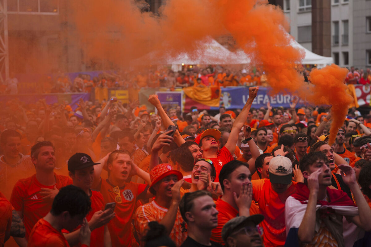 Netherlands fans celebrate the opening goal during a pubic screening of a semi final match between Netherlands and England
