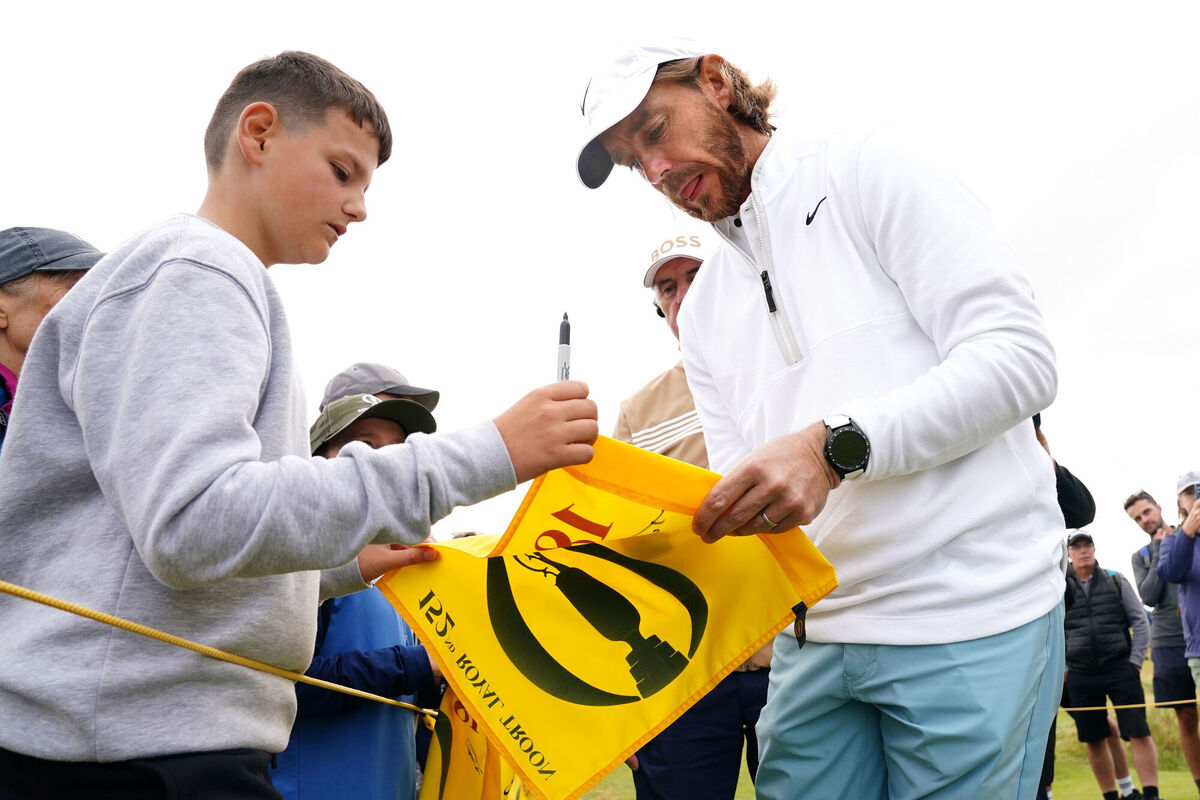 Tommy Fleetwood sign autographs on his way to the 5th tee during a practice day ahead of The Open