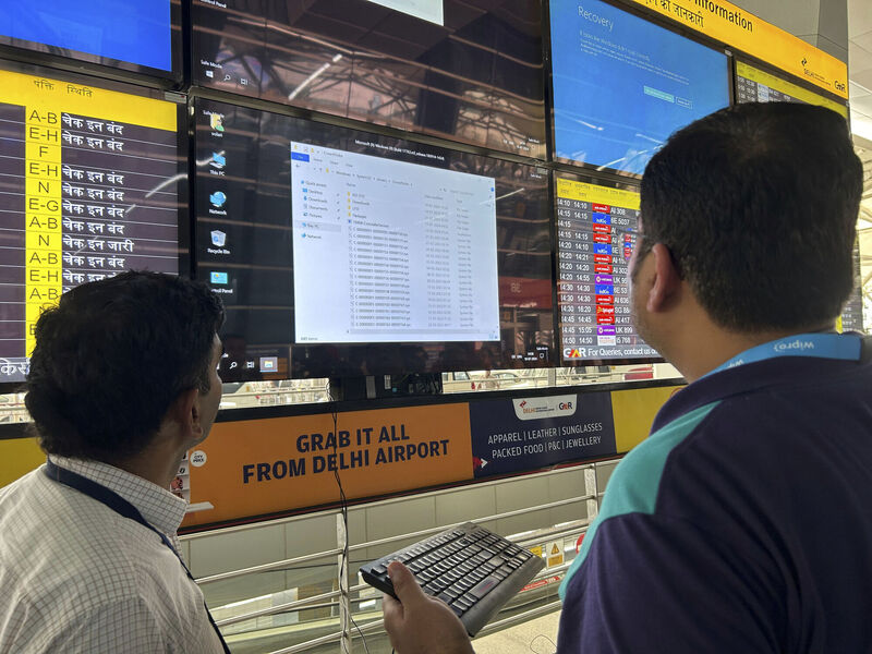 An airport official tries to reboot a flight information screen at the Indira Gandhi International Airport in New on Friday, after a widespread global technology outage disrupted flights, banks, media outlets and companies around the world. Picture: AP/Shonal Ganguly An airport official tries to reboot a flight information screen at the Indira Gandhi International Airport in New on Friday, after a widespread global technology outage disrupted flights, banks, media outlets and companies around the world. Picture: AP/Shonal Ganguly