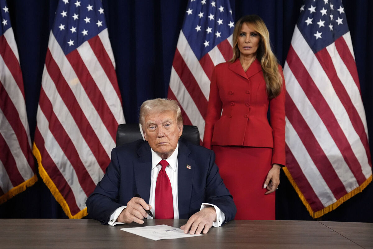 Donald Trump signs paperwork to officially accept the nomination during the final day of the Republican National Convention at the Fiserv Forum in Milwaukee, joined by his wife Melania. Picture: Evan Vucci/AP