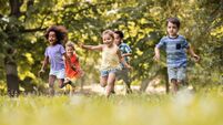 Group of happy children having fun while running in nature.