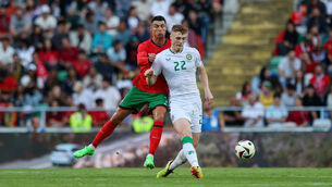 <p>ON THE MOVE: Portugal's Cristiano Ronaldo with Ireland's Jake O'Brien. Pic: Ryan Byrne, Inpho</p>