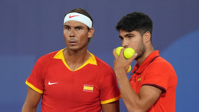 Rafael Nadal and Carlos Alcaraz talk during their first-round doubles match (Martin Rickett/PA)