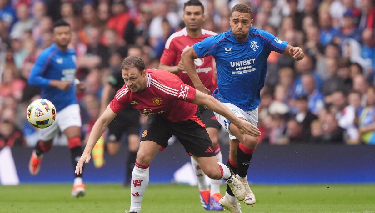 Manchester United's Jonny Evans is challenged by Cyriel Dessers during a pre-season friendly. Pic: Andrew Milligan/PA Wire. Manchester United's Jonny Evans is challenged by Cyriel Dessers during a pre-season friendly. Pic: Andrew Milligan/PA Wire.