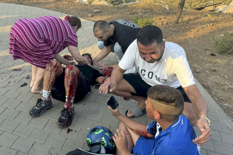 Residents rush to help injured children, moments after a rocket attack hit a soccer field in the Druze town of Majdal Shams in the Israeli-controlled Golan Heights, last Saturday. Picture: Hassan Shams/AP Residents rush to help injured children, moments after a rocket attack hit a soccer field in the Druze town of Majdal Shams in the Israeli-controlled Golan Heights, last Saturday. Picture: Hassan Shams/AP