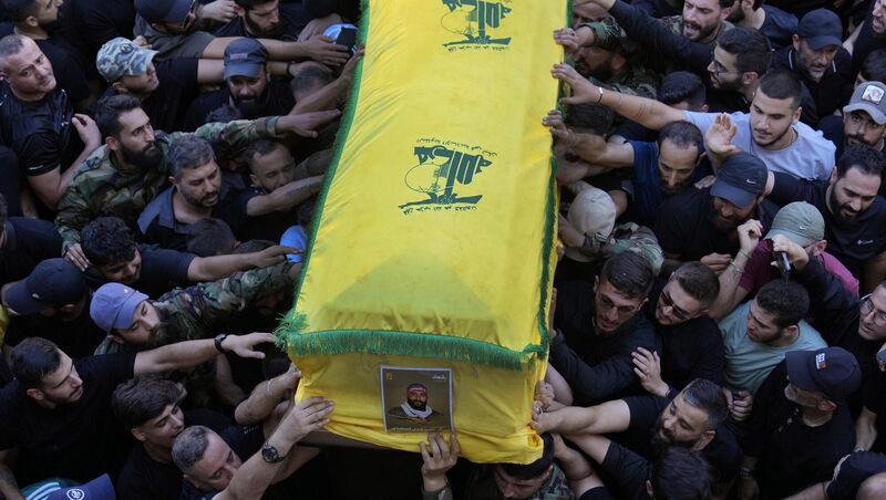 Mourners carry the coffin of a Hezbollah fighter who was killed along with three other fighters last Saturday by an Israeli airstrike in south Lebanon, during their funeral procession in the southern suburb of Beirut, Lebanon, last Sunday. Picture: Hussein Malla/AP Mourners carry the coffin of a Hezbollah fighter who was killed along with three other fighters last Saturday by an Israeli airstrike in south Lebanon, during their funeral procession in the southern suburb of Beirut, Lebanon, last Sunday. Picture: Hussein Malla/AP