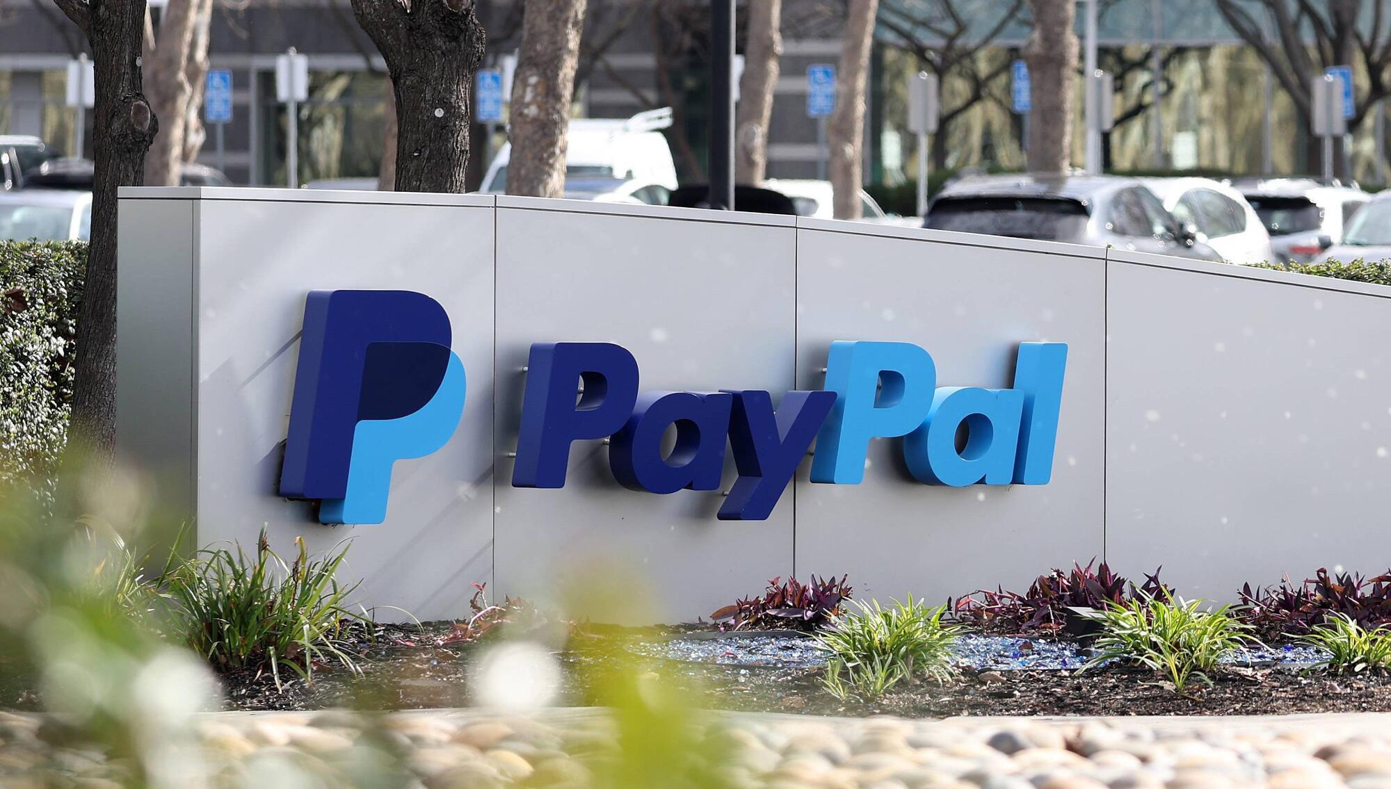 PayPal raises profit forecasts following series of job cuts
