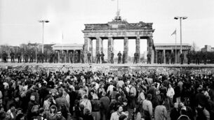 <p>A crowd of people are separated from the Brandenburg gate by the Berlin Wall on November 10, 1989. File picture: Paul O'Driscoll</p>