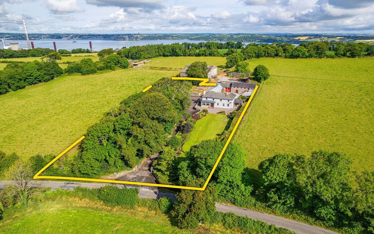Farmhouse with harbour in the background