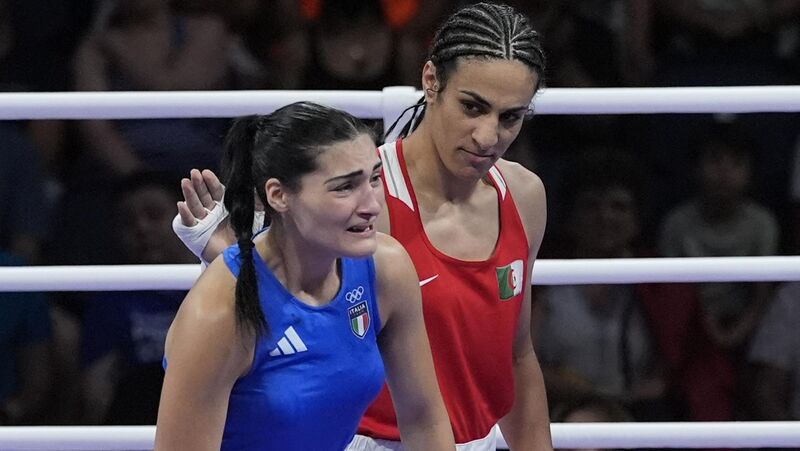 Algeria's Imane Khelif, red, with Italy's Angela Carini at the end of their women's 66kg preliminary match in Paris. Picture: John Locher/AP